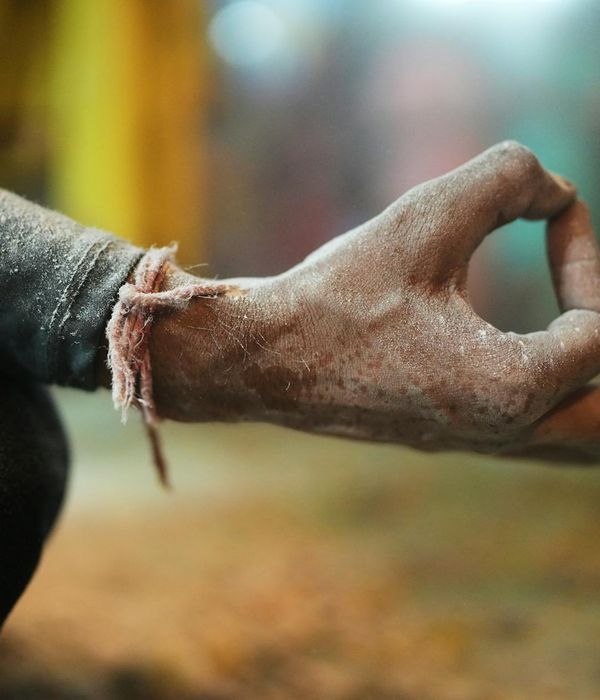 Close-up of a person's hands in a meditative mudra gesture.